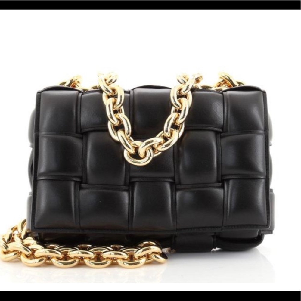 Black woven bag with snap closure wallet on the inside.